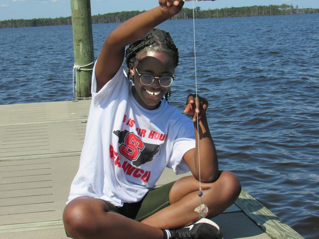 Senior Selma O. (dual degree in Biochemistry and Spanish) checks her crabbing line at the Jefferson Scholars annual fall retreat, held this year at the 4-H Center in Columbia, NC.