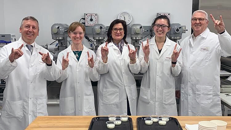 NC State Chancellor Randy Woodson and CALS Dean Richard Linton visit alumna Katie Maloney and Novozymes lab colleagues