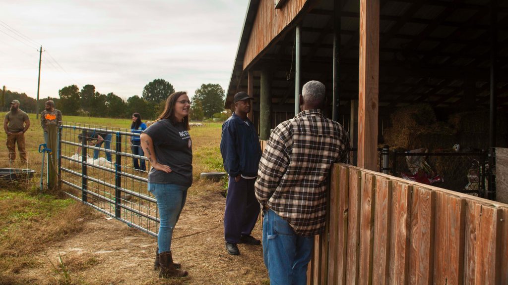 Sara Kidd chats with friends who are farmers.