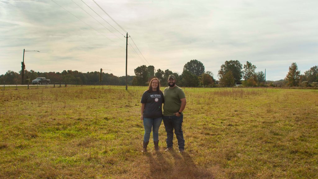 Sara and Joe Kidd stand on their farm.