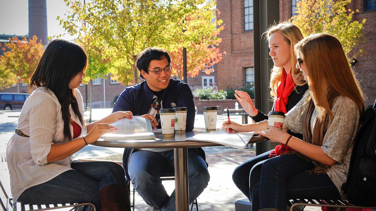 students enjoying each other while drinking coffee and studying