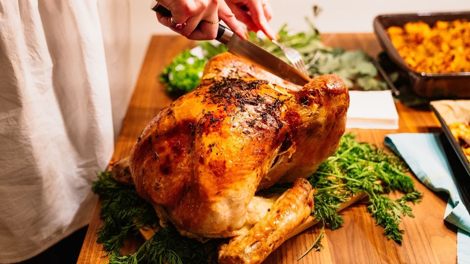 a roast turkey rests on a kitchen counter