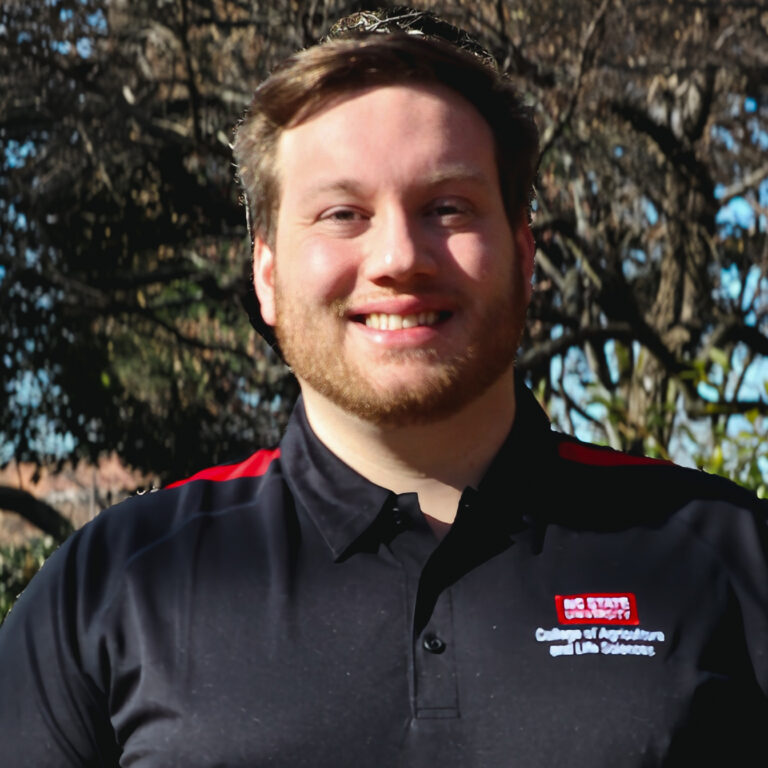 Young man in black shirt smiling