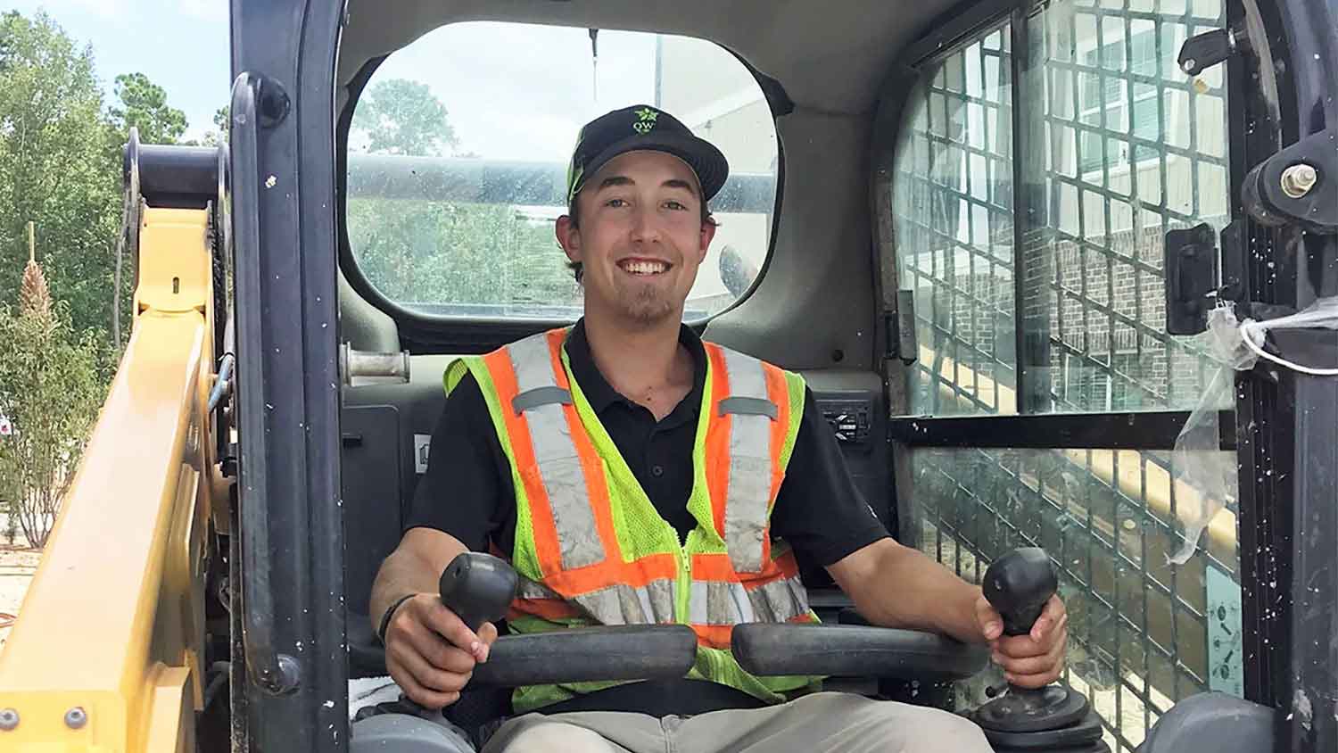 a man in a tractor with construction gear