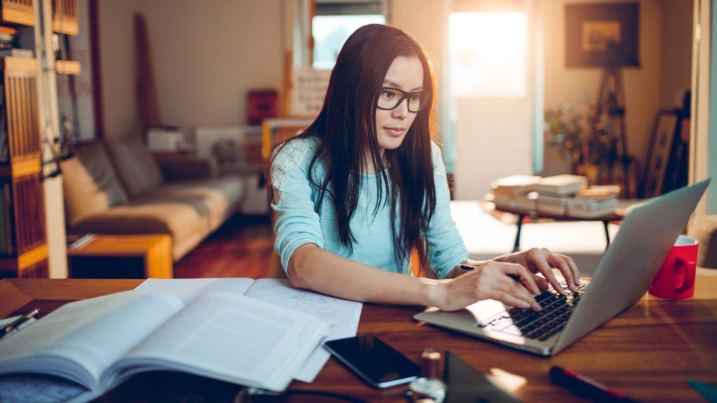 Student typing on a laptop