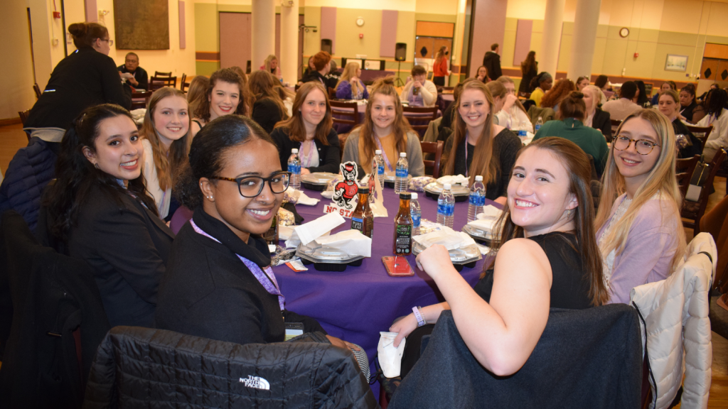 group of student smiling at table