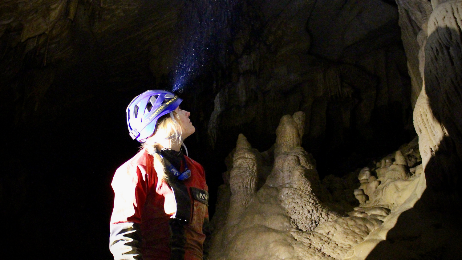 a female researcher in a dark cave