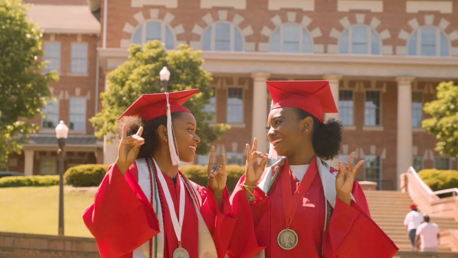 two female graduates on campus