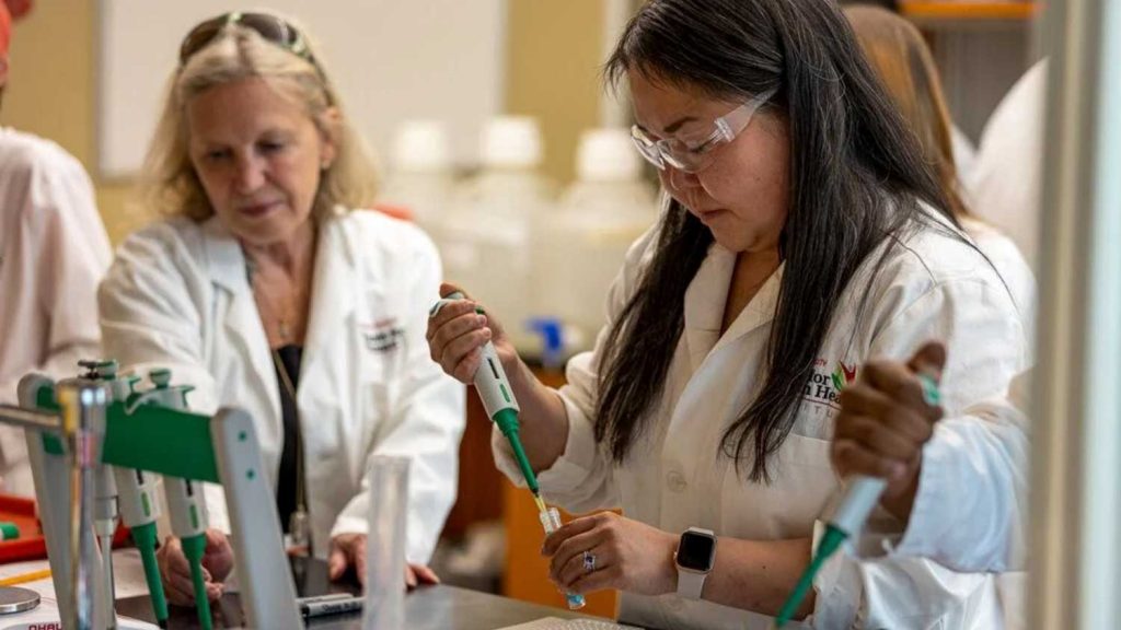 a student with a pipette in Mary Ann Lila's research lab