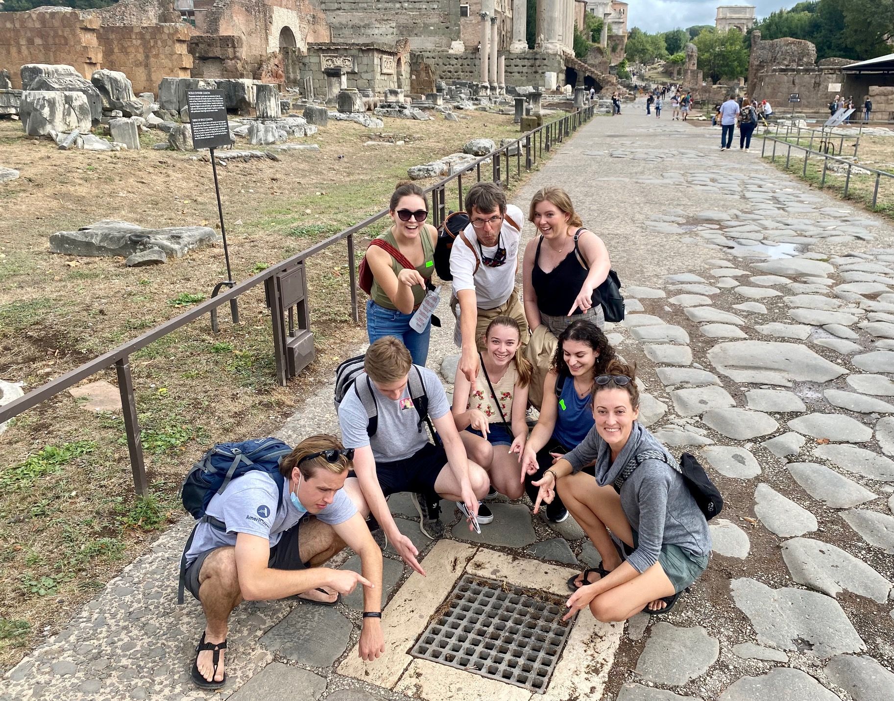 a group of students near a water drain in Italy as part of stduy abroad program