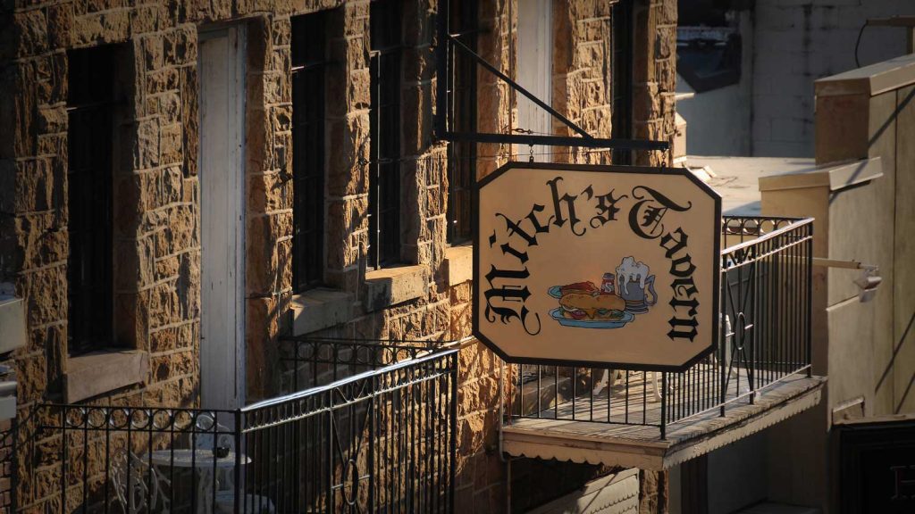 The sign hanging from Mitch's Tavern on Hillsborough Street