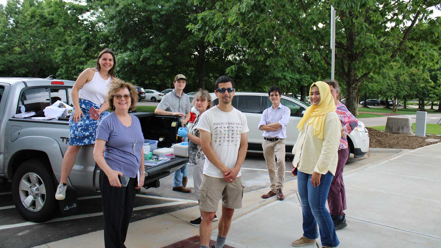 a group of people standing outside posing for a photo