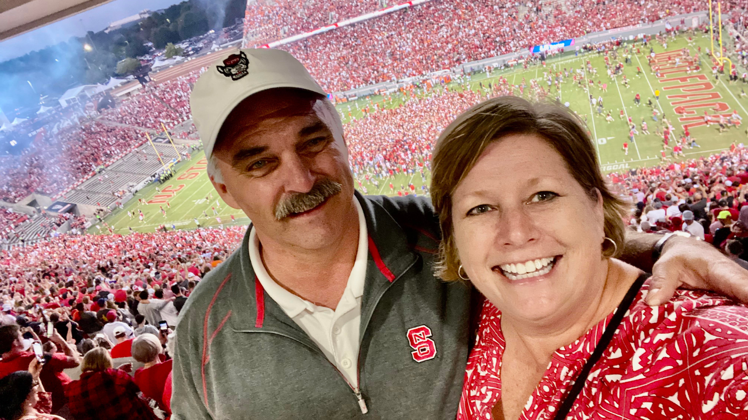 Bryan Blinson and his wife, at a NC State football game
