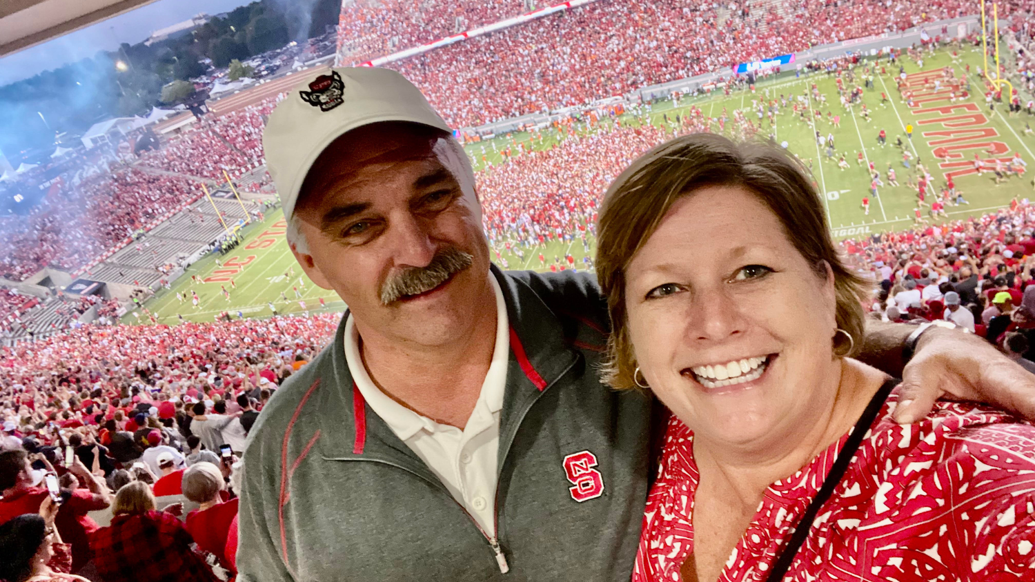 Bryan Blinson and his wife, at a NC State football game