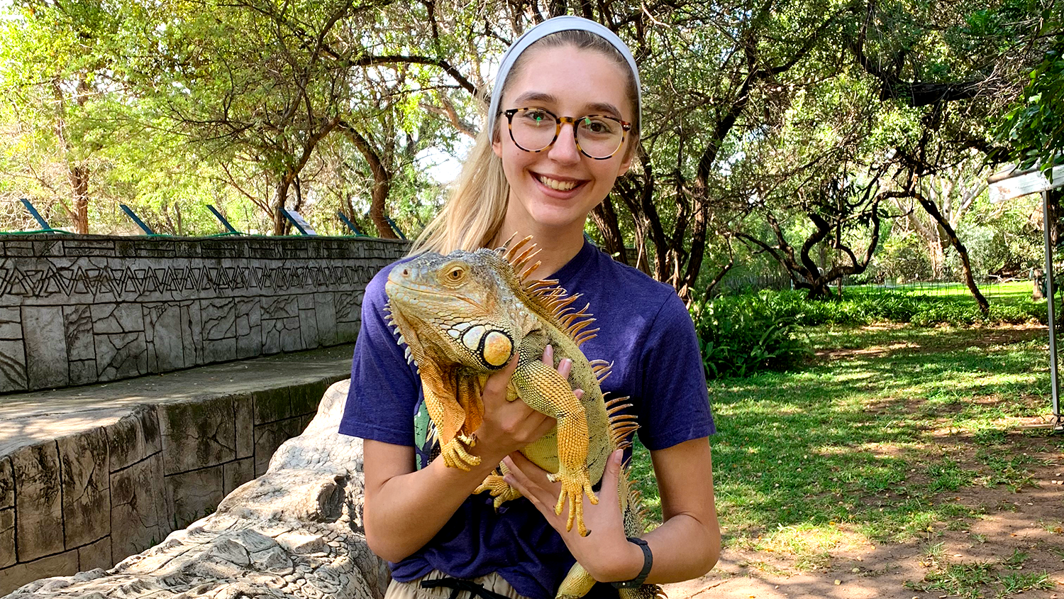 Female student holding iguana