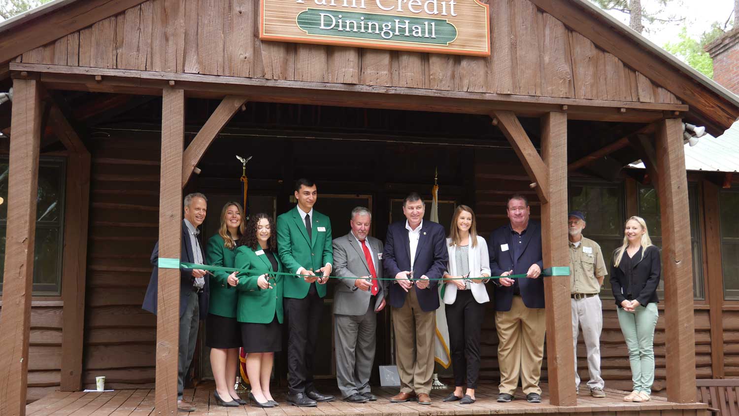 A group of people cutting a ribbon