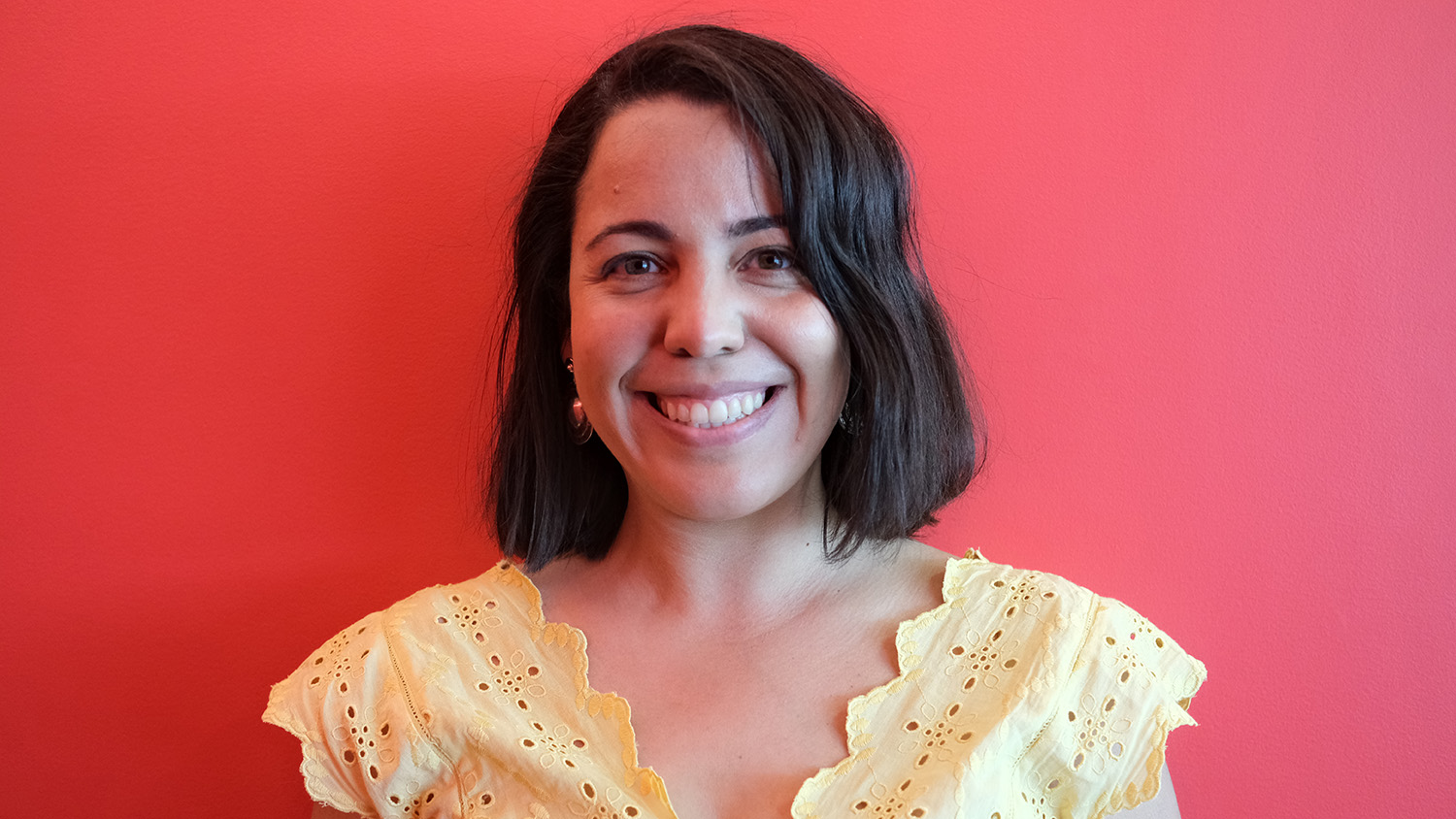 Young woman in a yellow blouse smiling