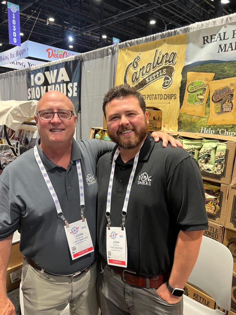 Josh Monahan and his father at a trader show