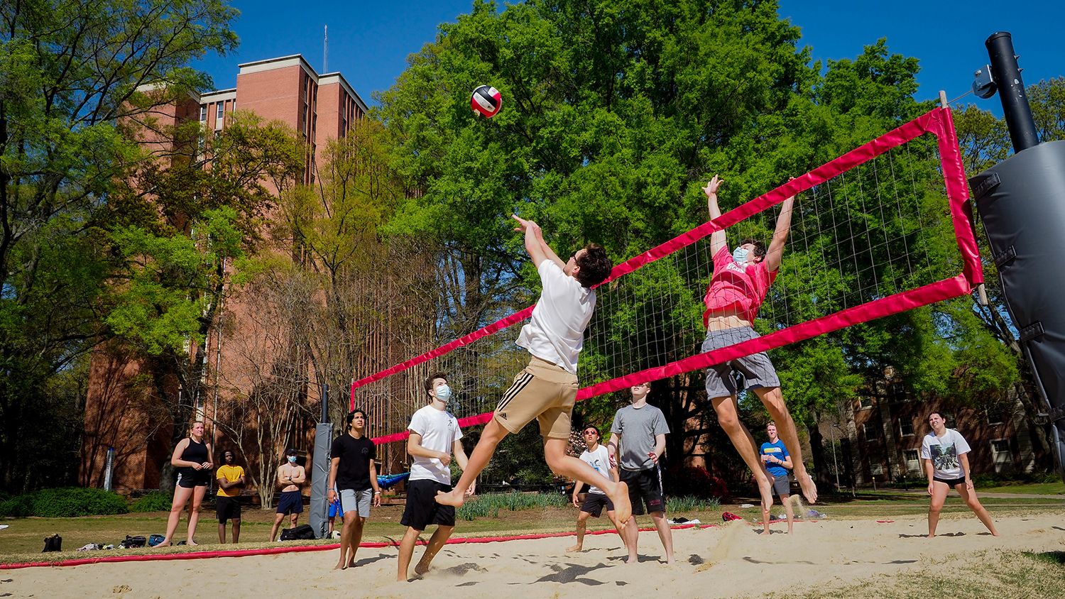 Students enjoy a spring afternoon at Tucker Beach playing volleyball.