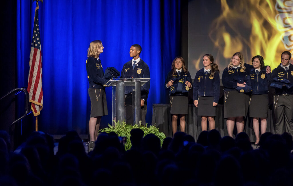 an FFA officer shaking a hand on stage