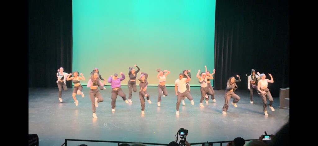 a dance team performs on stage