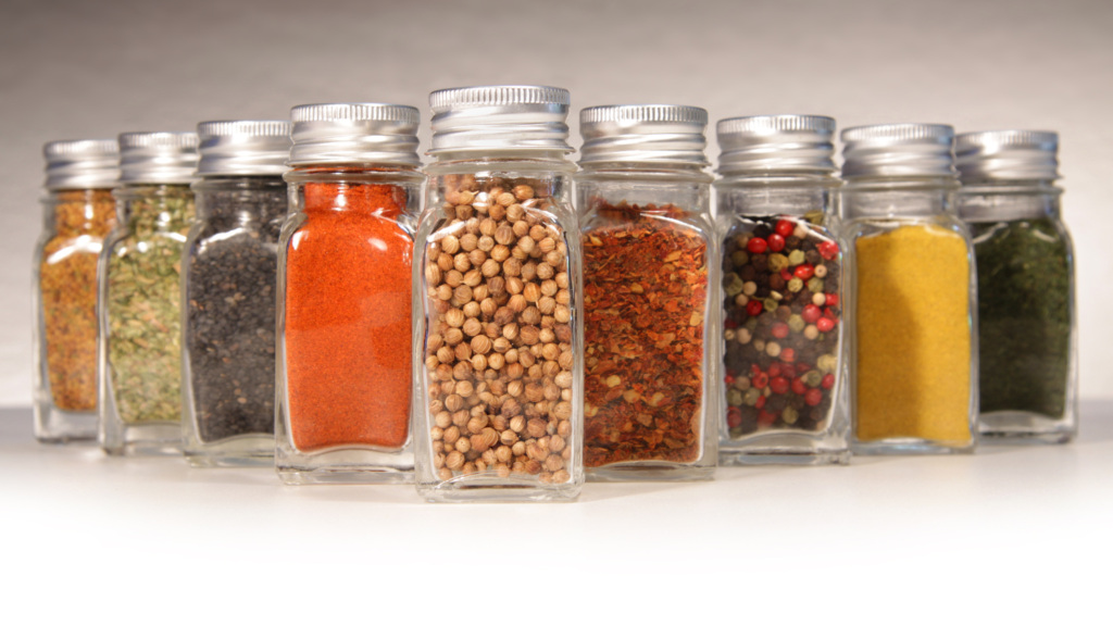 several spice jars lined up on a table