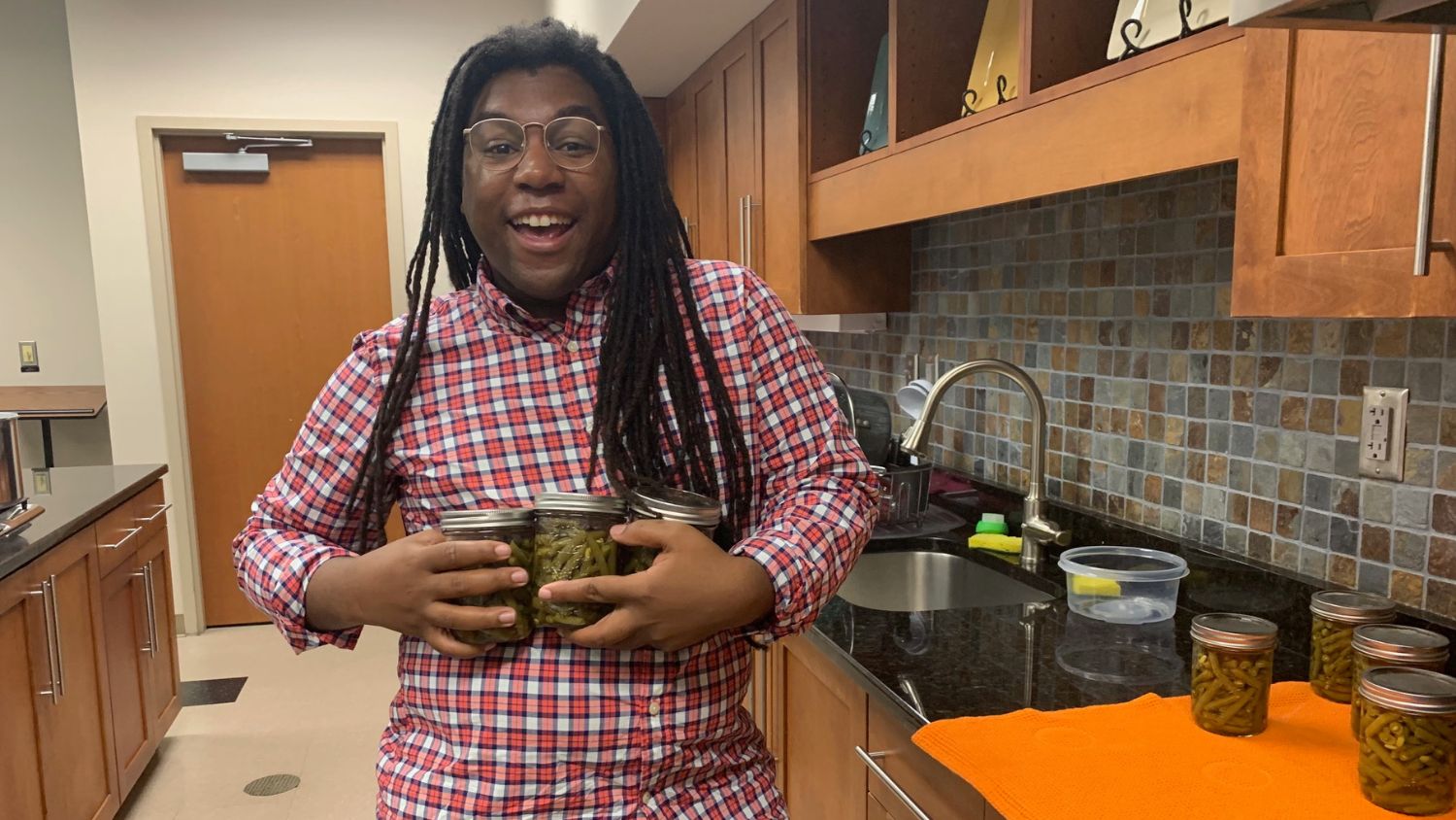 Marcus McFarland with jars of preserved food