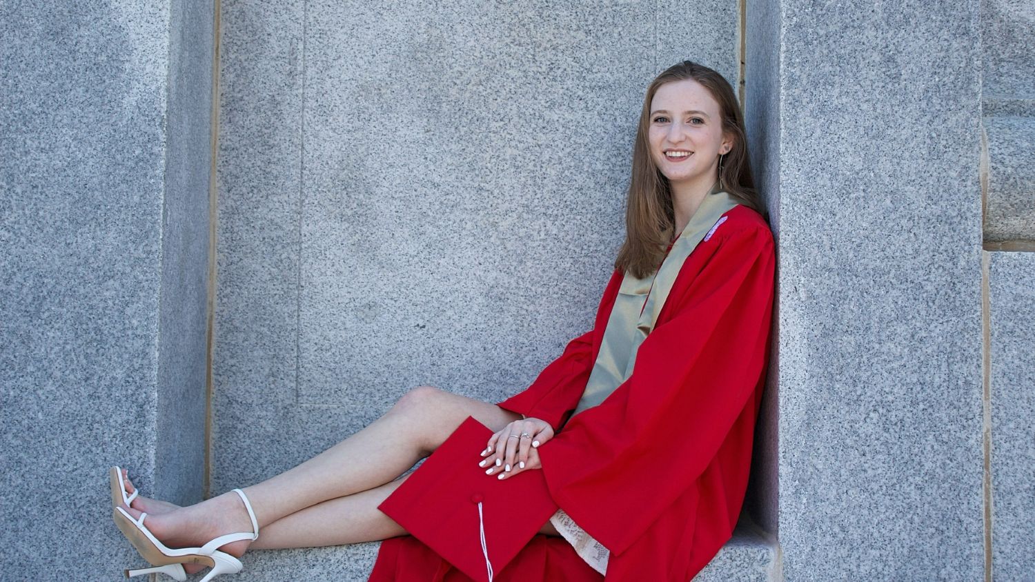 a female NC State graduate at the Belltower