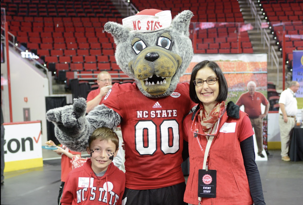 Sonia Murphy and her son with Mr. Wuf on a basketball court