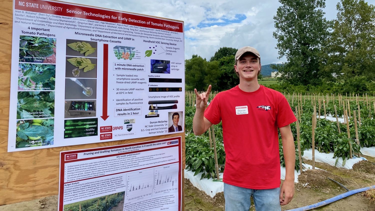 A male undergraduate student presenting a poster in a field