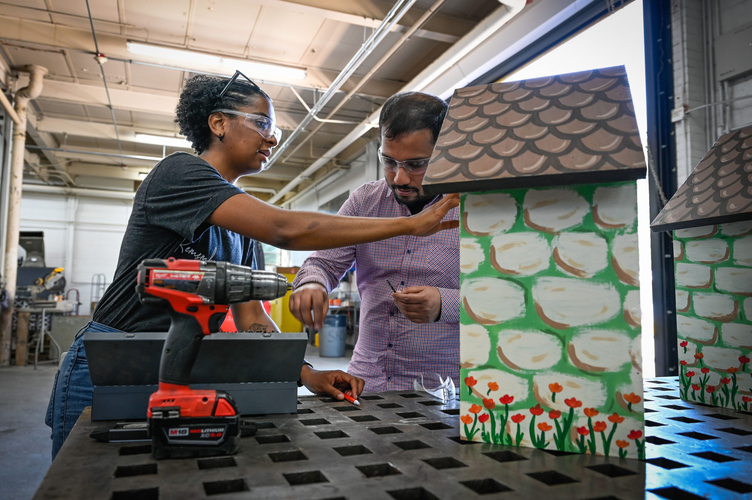 female and male student working on garden project