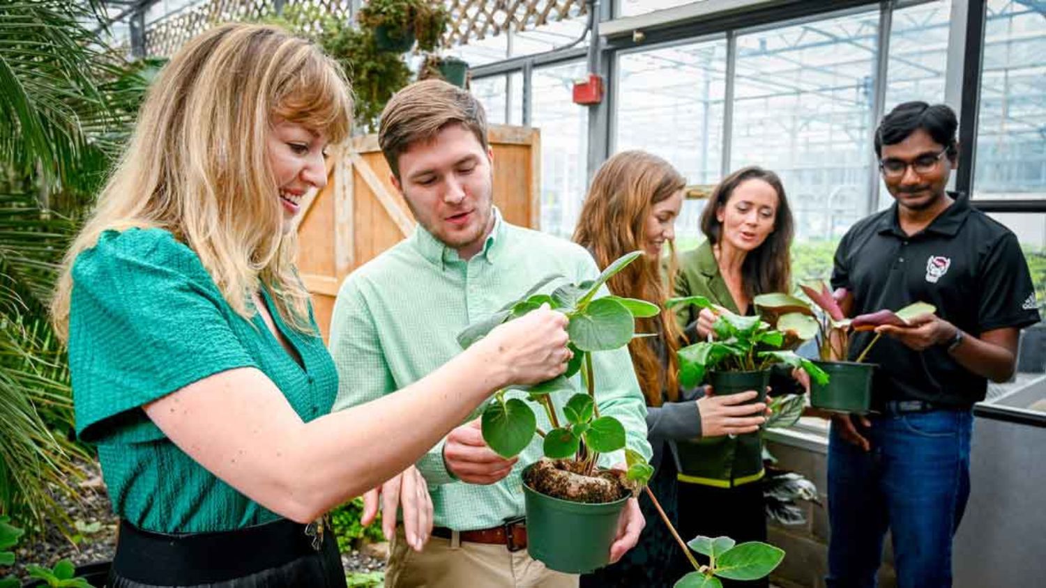 students looking at plants in a lab