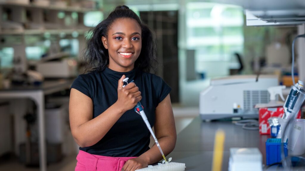 Imani Madison holding a pipette in a lab