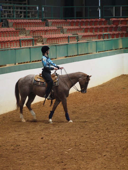 Amber Davis in college riding a horse as part of the Equestrian Team