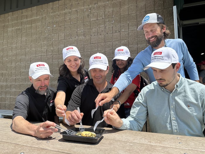 several people tasting a flounder meal from Local Seafood