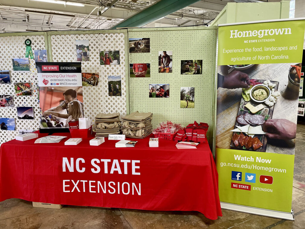 nc state extension booth with images of food and farmers