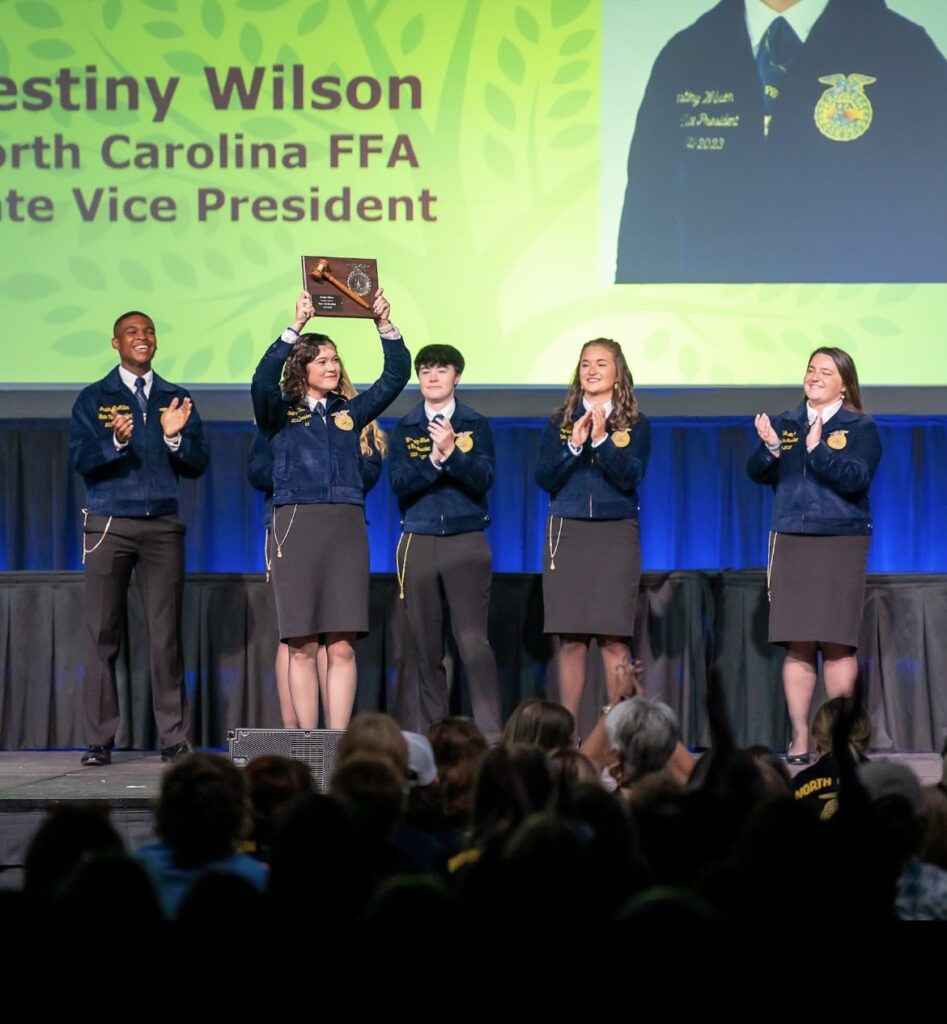 High school students standing on a stage