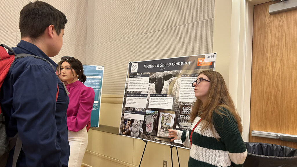 students in a ballroom with poster presentations