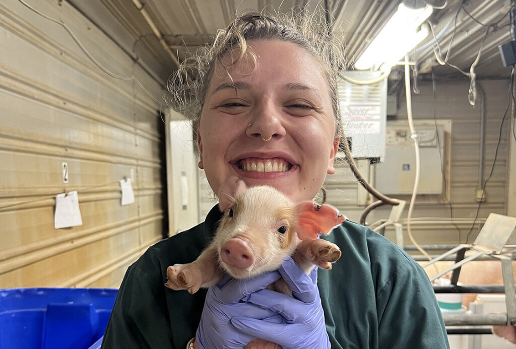young woman holds piglet