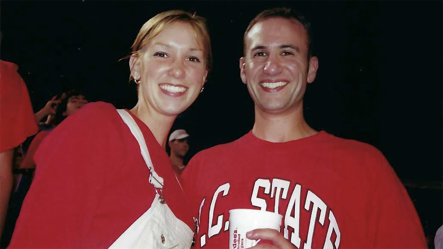 a woman and man wearing red shirts