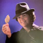Jean Ristaino in detective costume holding leaf
