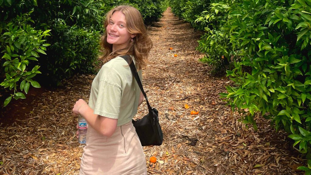 Young woman in orange orchard