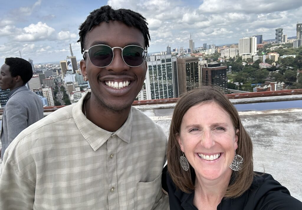 People on a roof with the skyscrapers in Nairobi in the background.