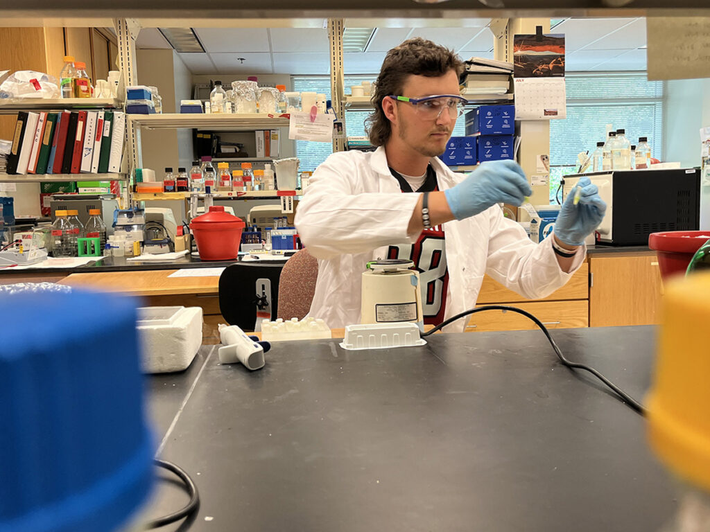 a man wearing a lab coat in a science lab