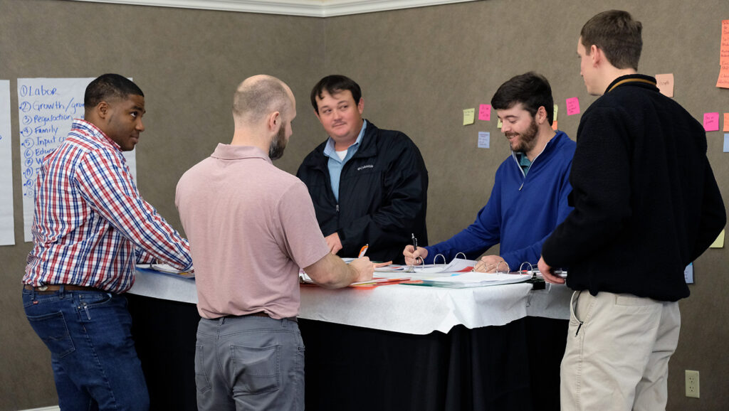 men standing around a table