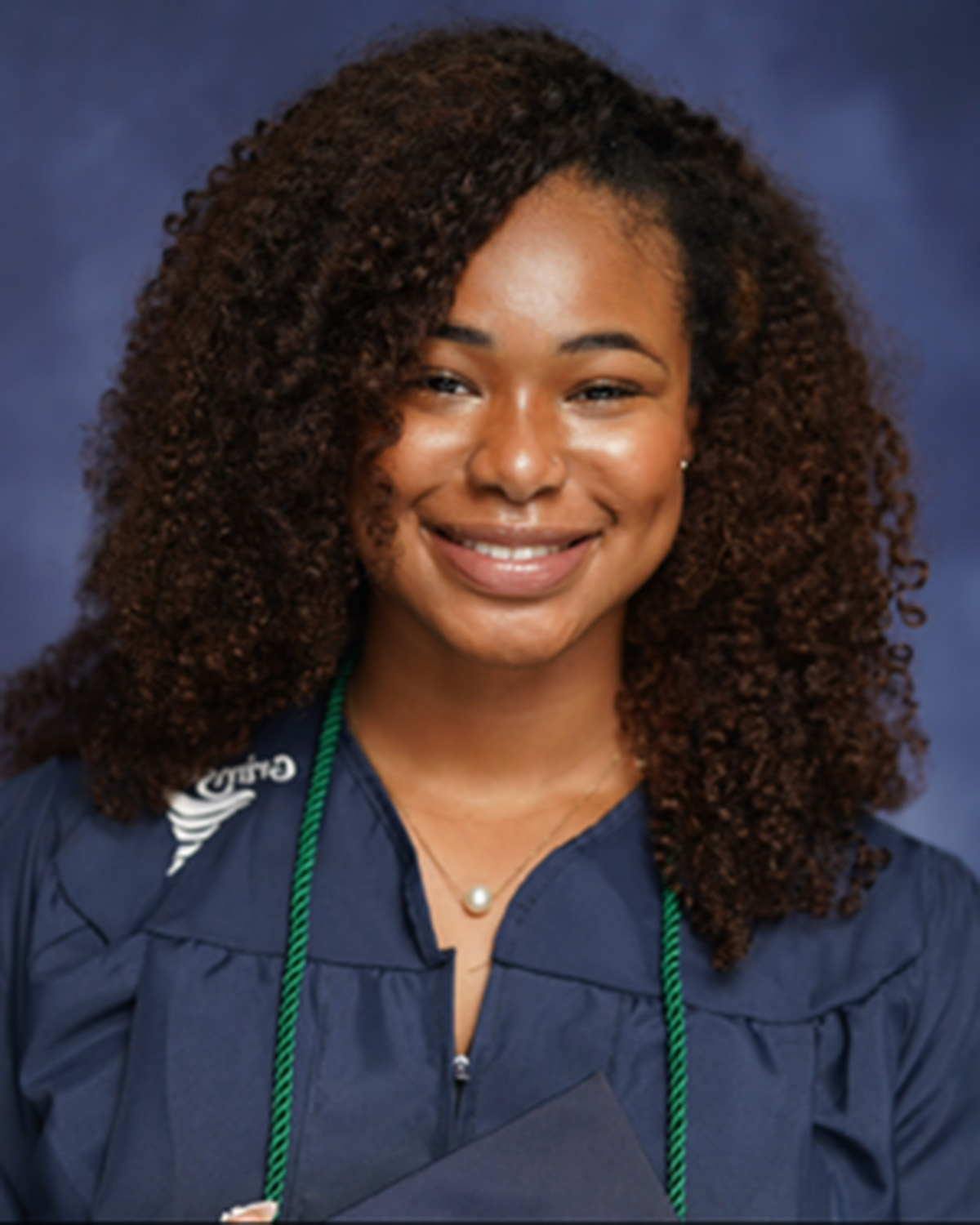 A young woman in a navy blue graduation gown