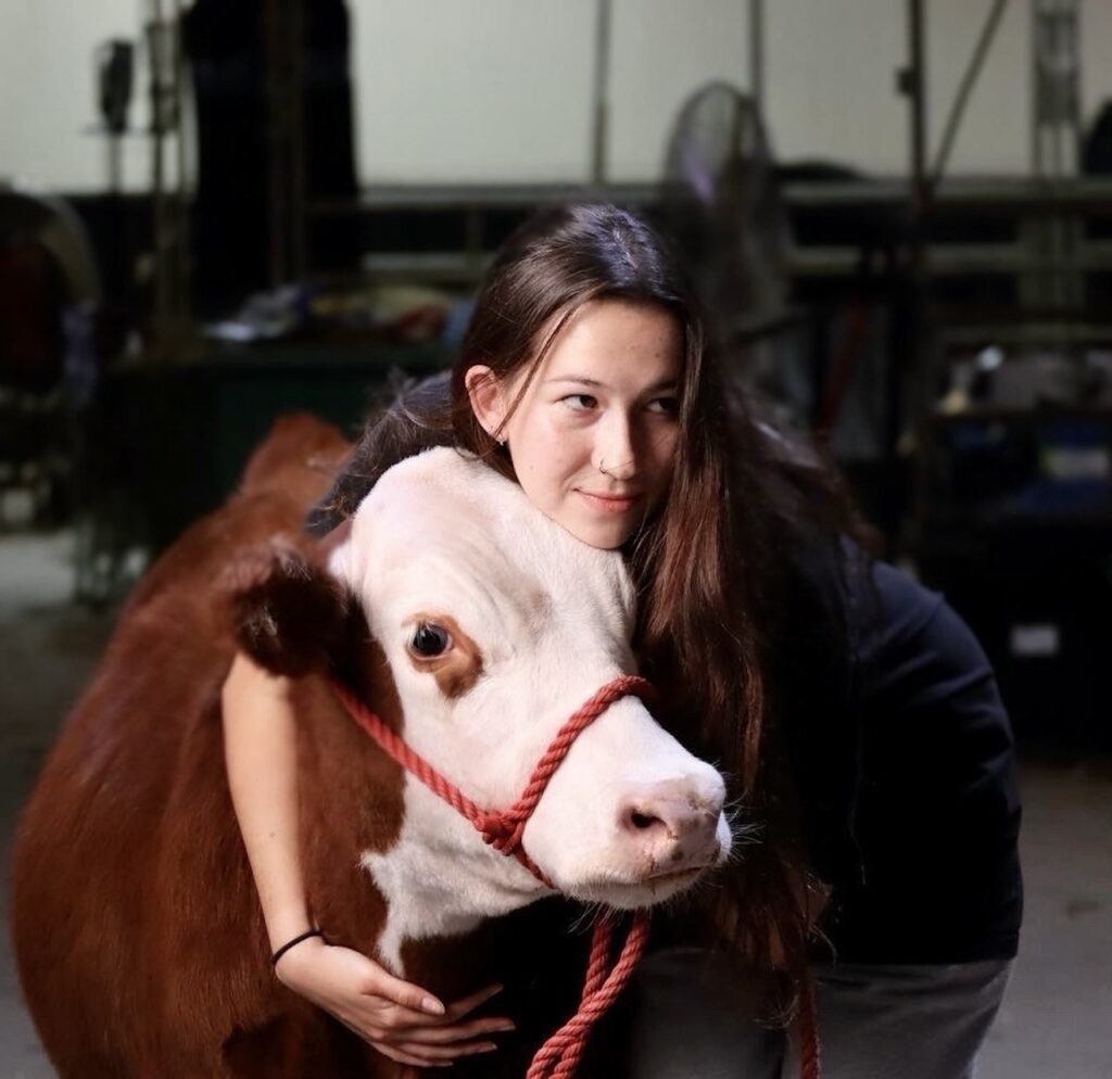 a woman hugs a cow