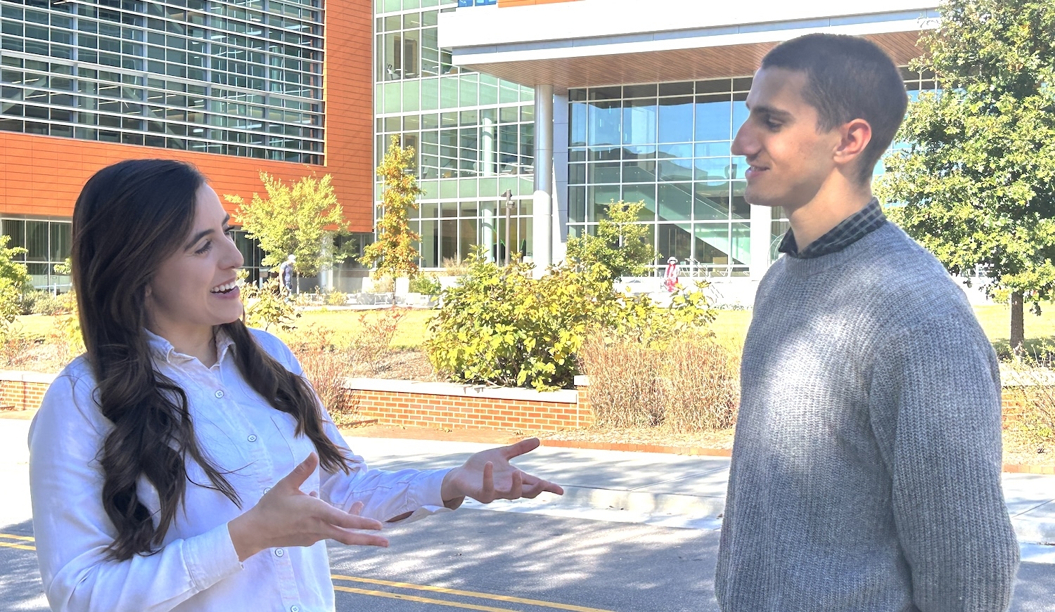 A woman and a man standing outside in front of the Plant Sciences Building