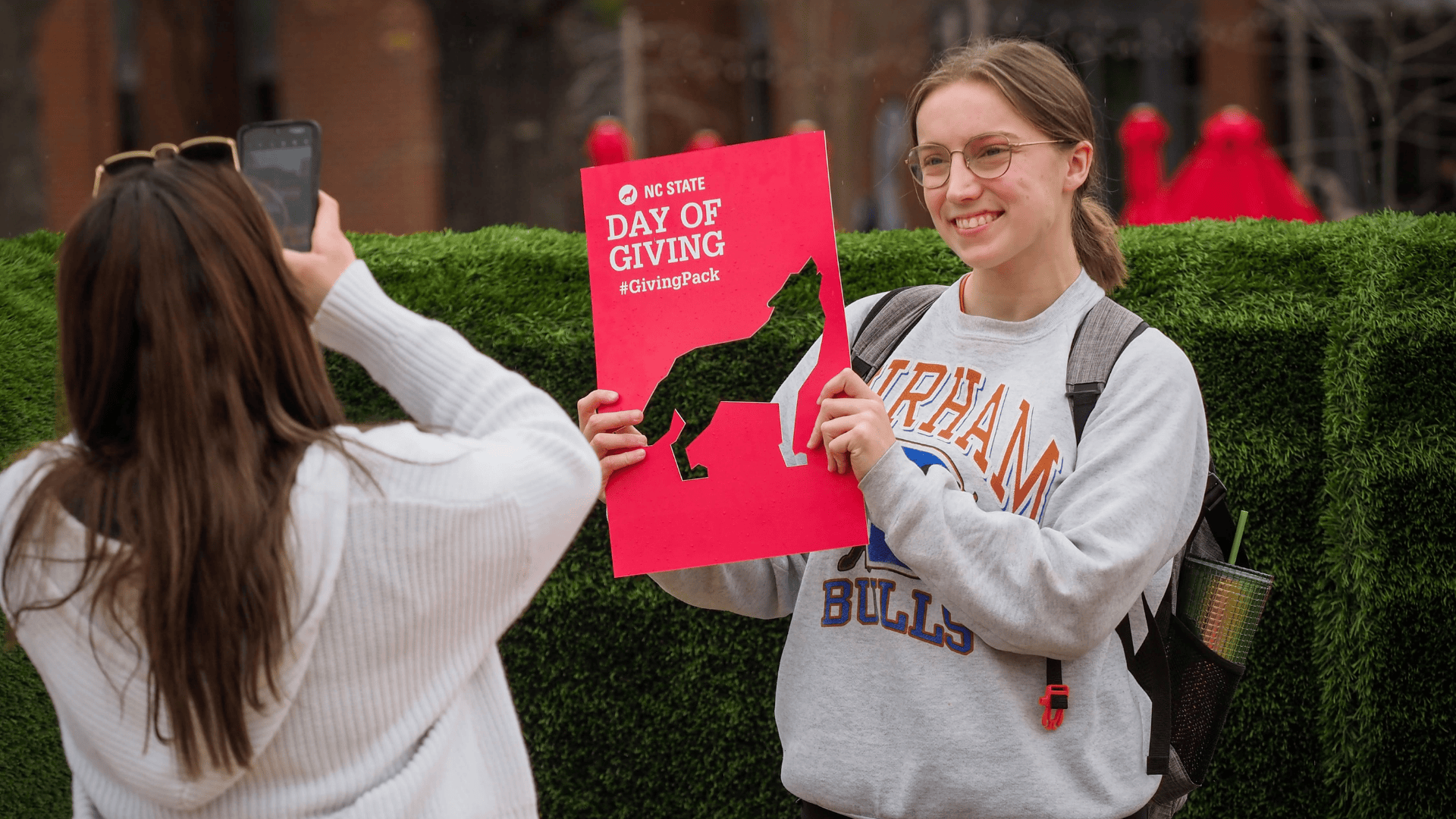 student holding day of giving sign