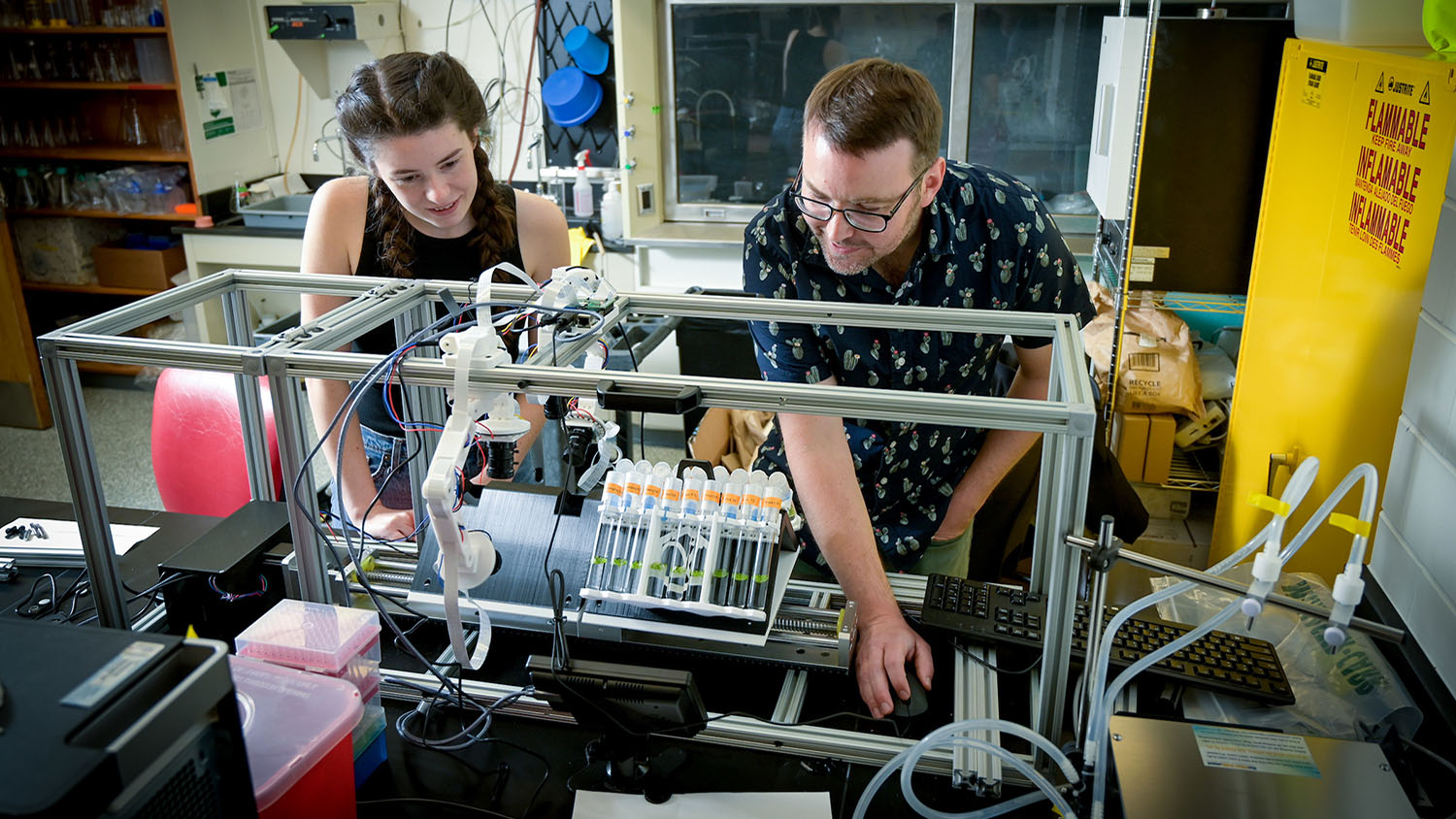 a man and woman conducting a science experiment in a lab